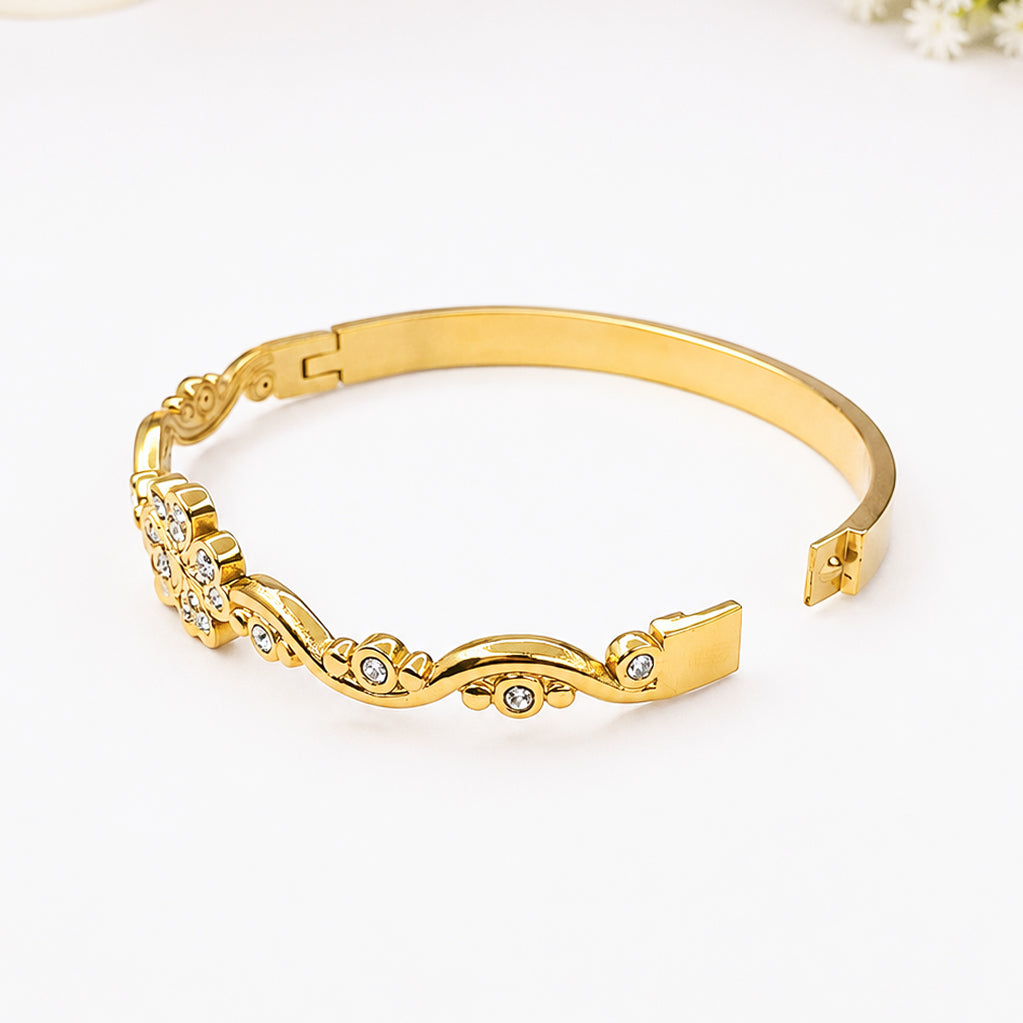 Elegant gold-plated bangle bracelet with sparkling crystal flower and wave design