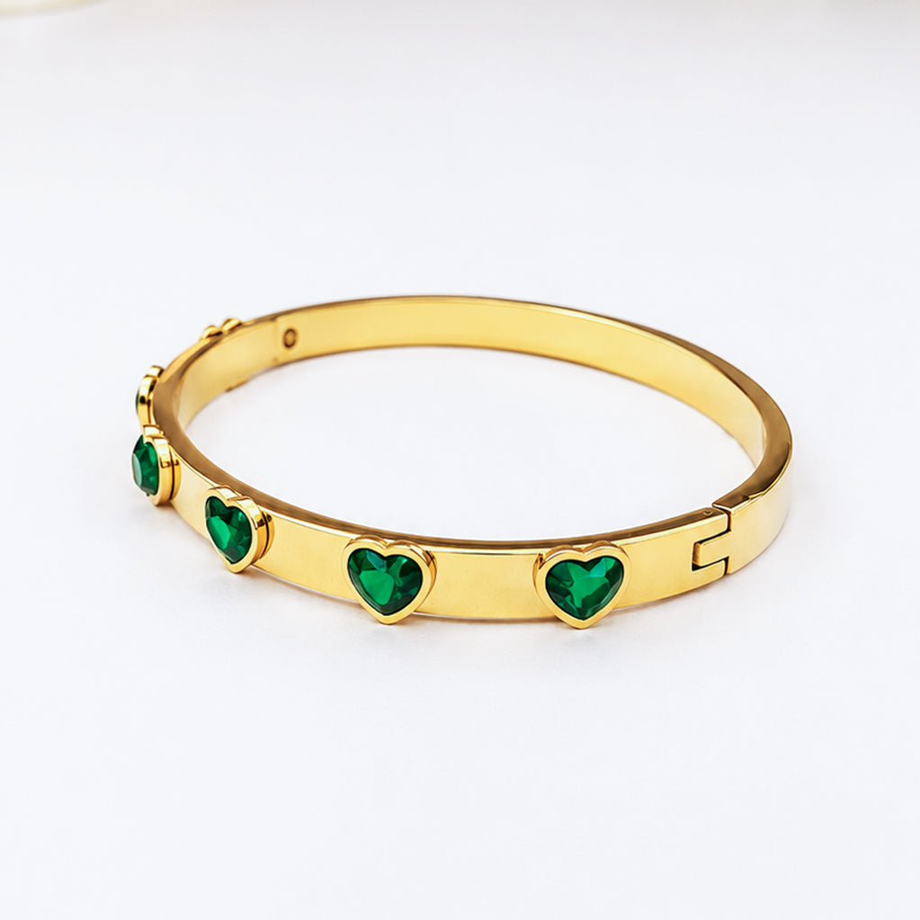 Gold-plated bangle bracelet with heart-shaped green crystals