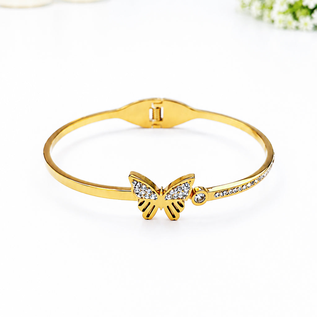 Gold-plated bangle bracelet featuring a sparkling cubic zirconia butterfly charm