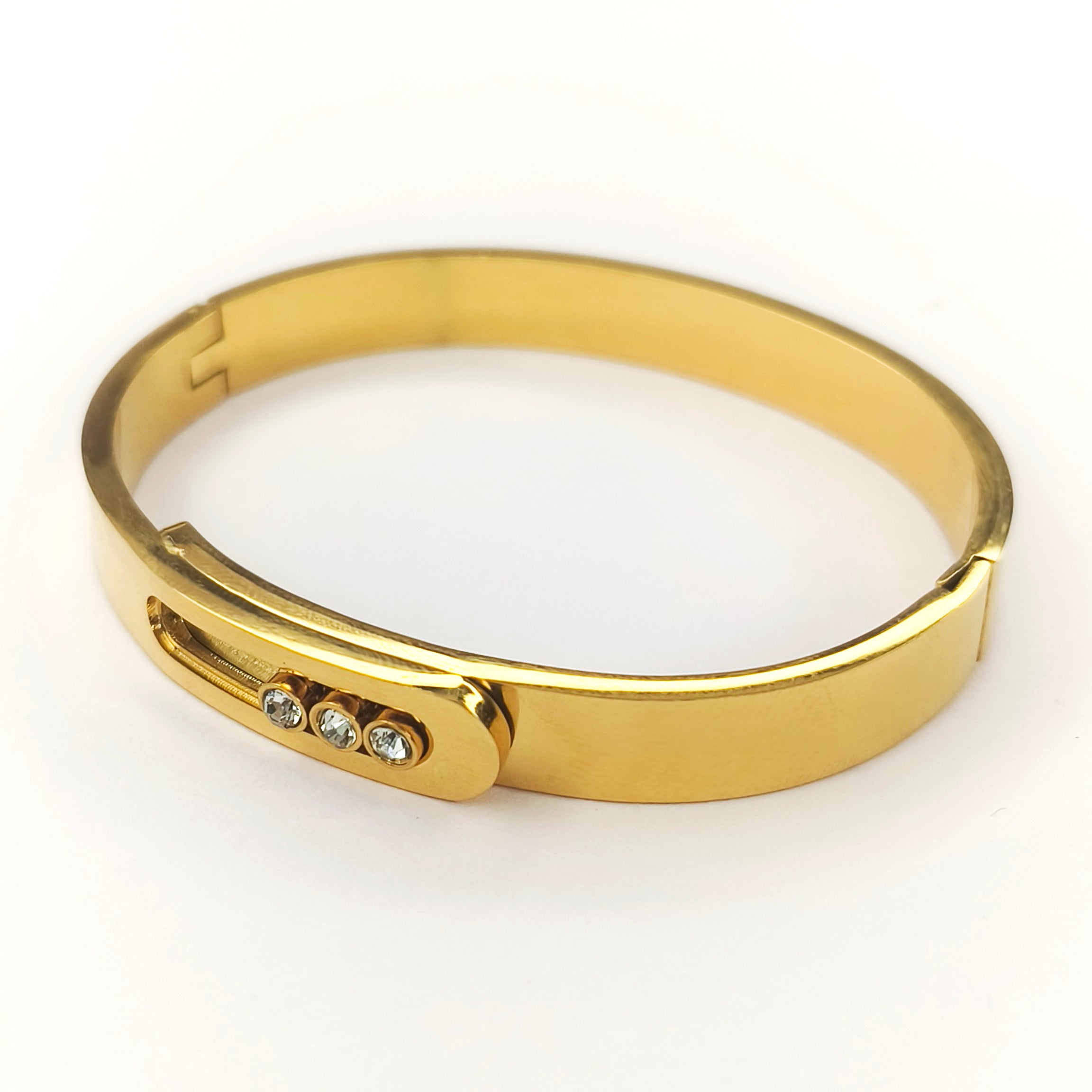 Elegant gold-plated bangle bracelet featuring three inlaid sparkling crystals.