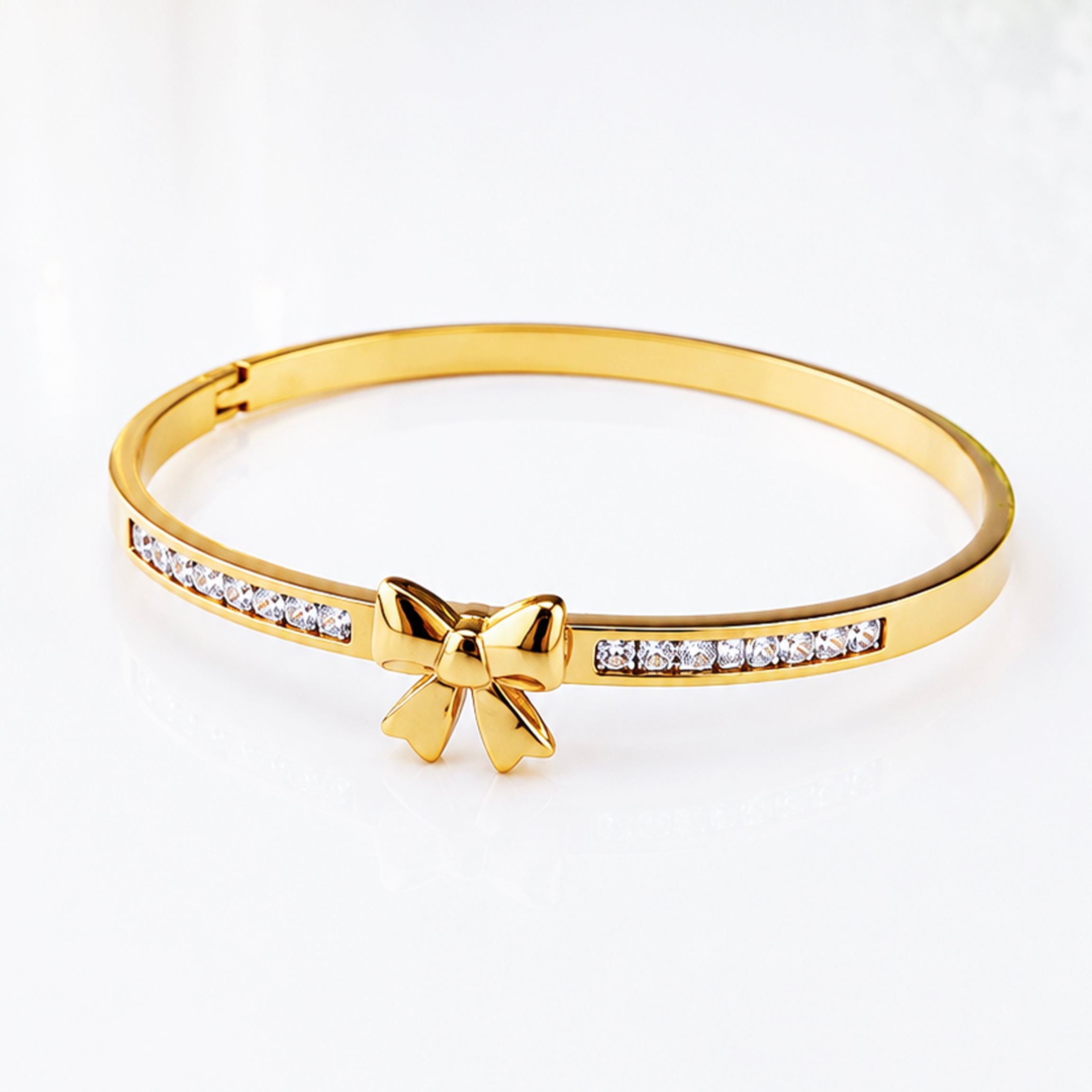 Gold bow charm bangle bracelet with sparkling crystal accents