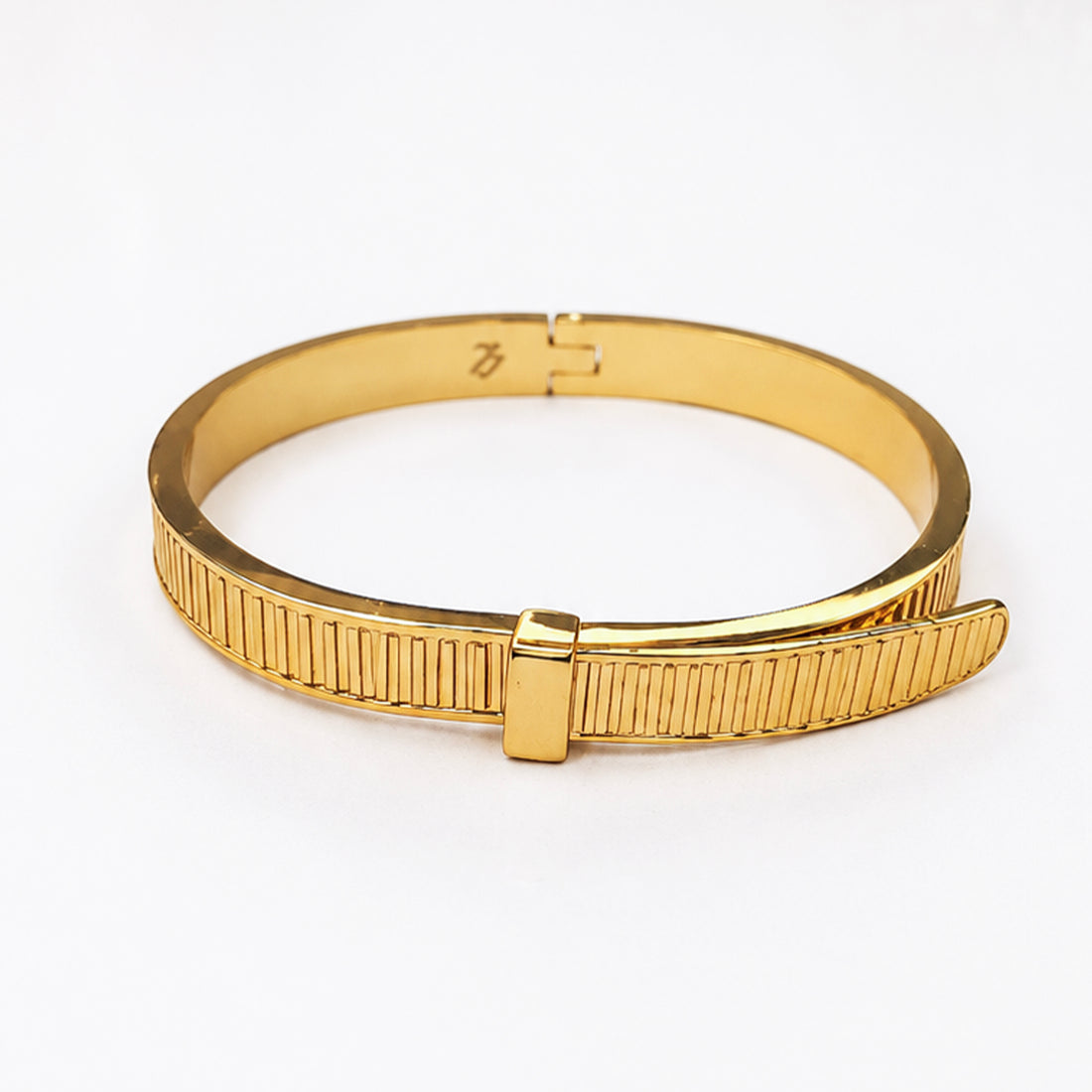Elegant gold-plated bangle bracelet with a textured ribbed design and hinge closure.