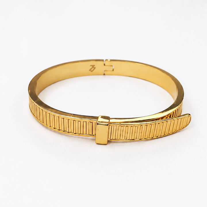 Elegant gold-plated bangle bracelet with a textured ribbed design and hinge closure.