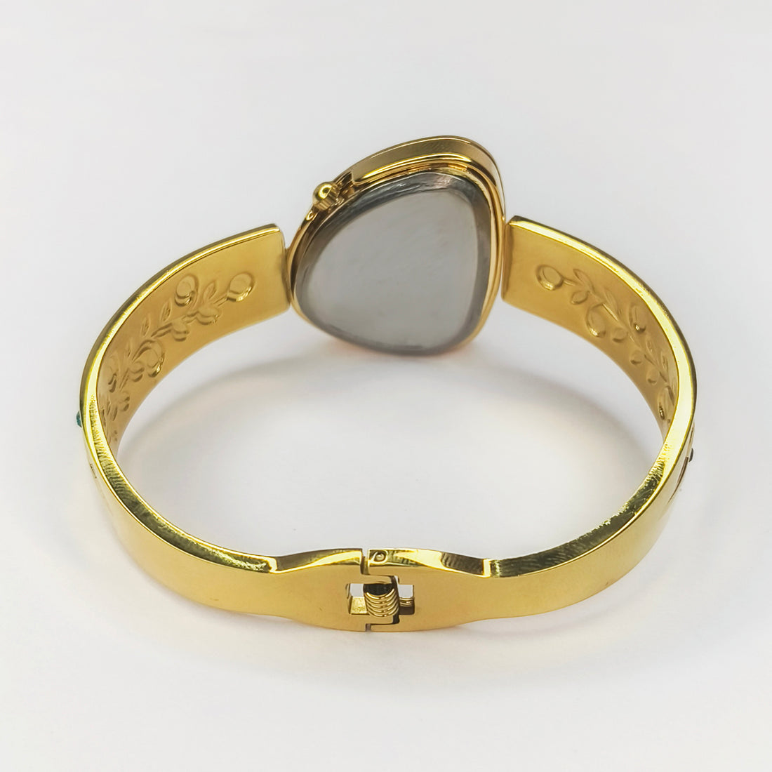 Gold-toned bangle watch with an oval face and etched leaf details on the band
