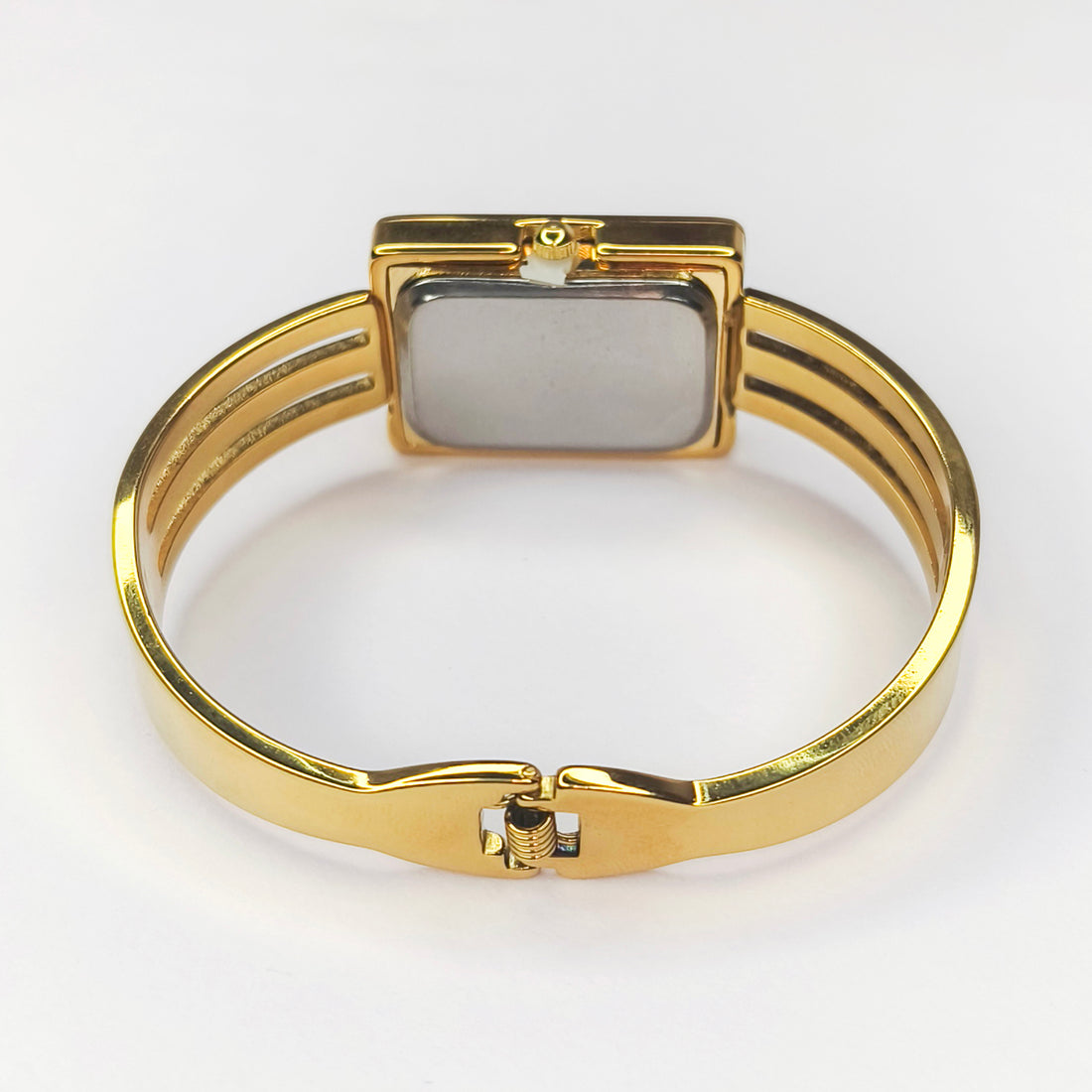 Elegant gold-toned bangle watch with a rectangular face and slim metal band.