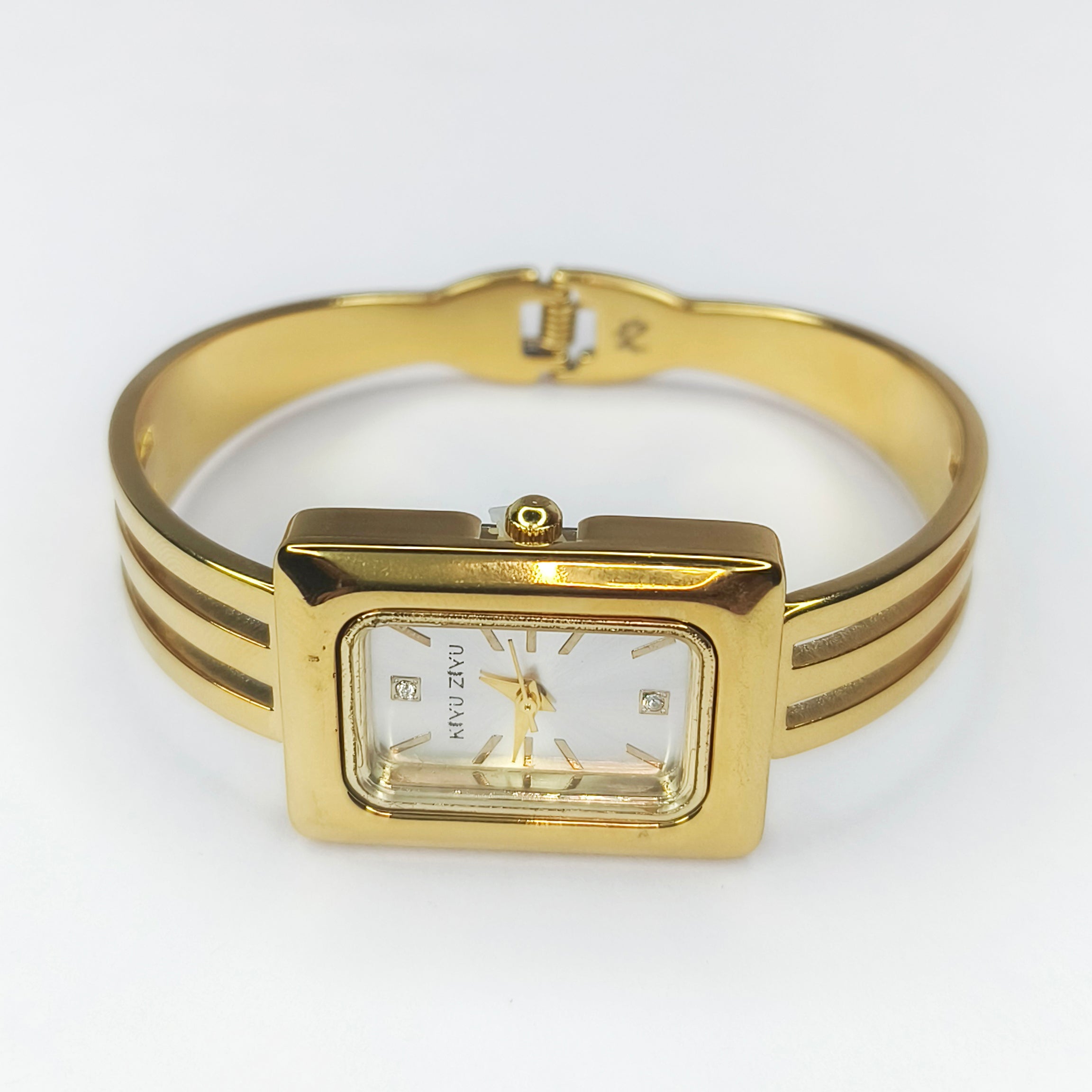 Elegant gold rectangular women's wristwatch with a slim metal bracelet.