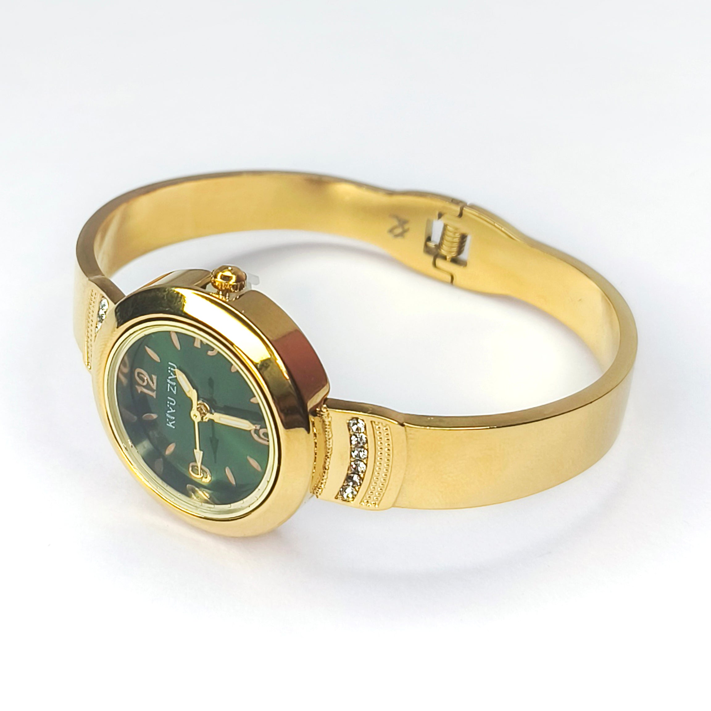 Elegant gold women's watch with a green dial and sparkling crystal accents on the band.