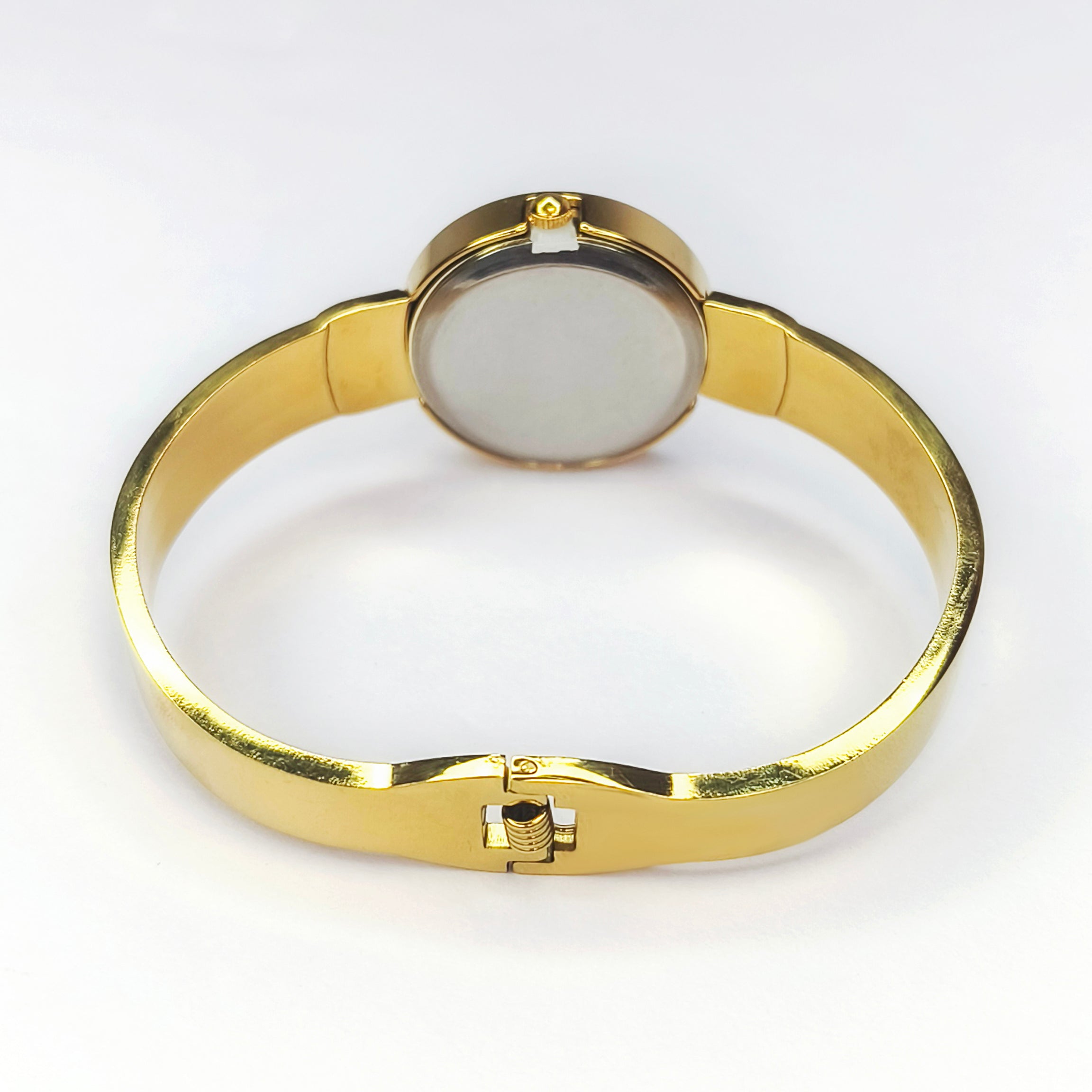 Elegant gold-tone bangle watch with a round minimalist face and polished metal strap.
