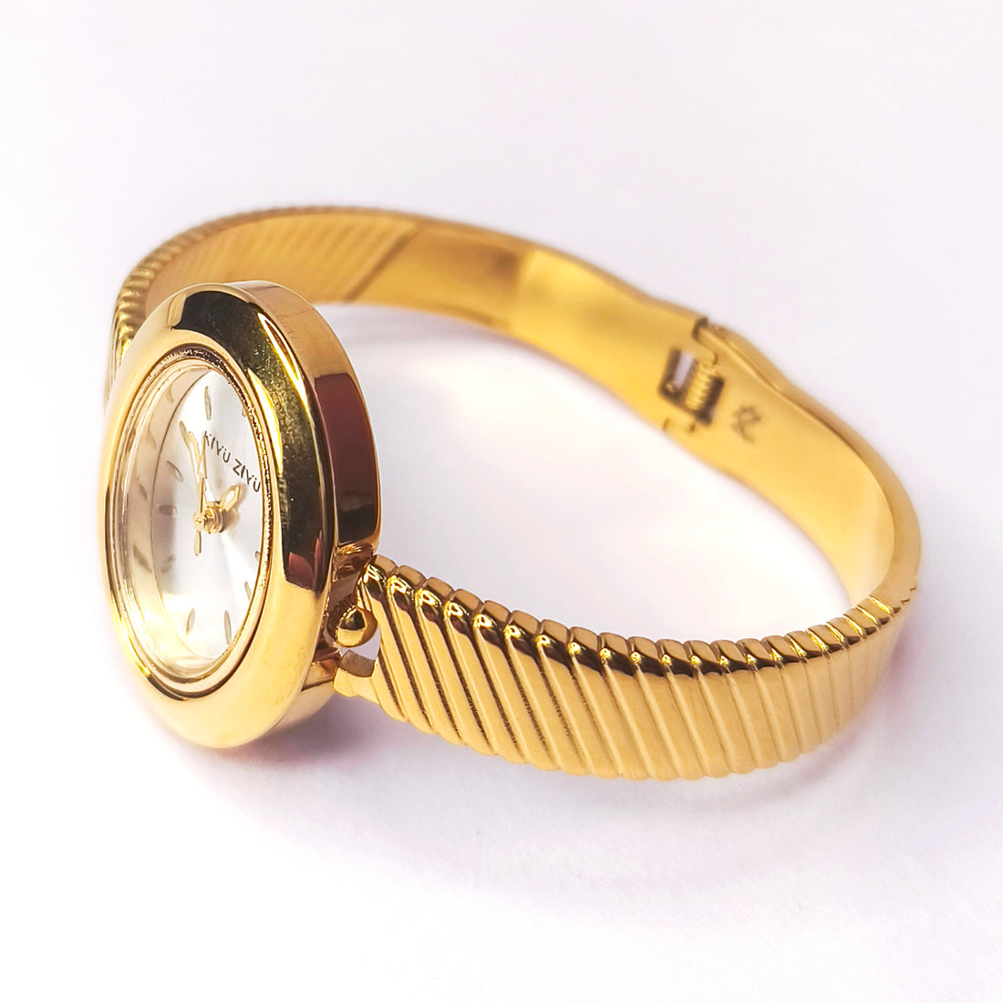 Elegant gold-tone women's bracelet watch with a textured ribbed band.