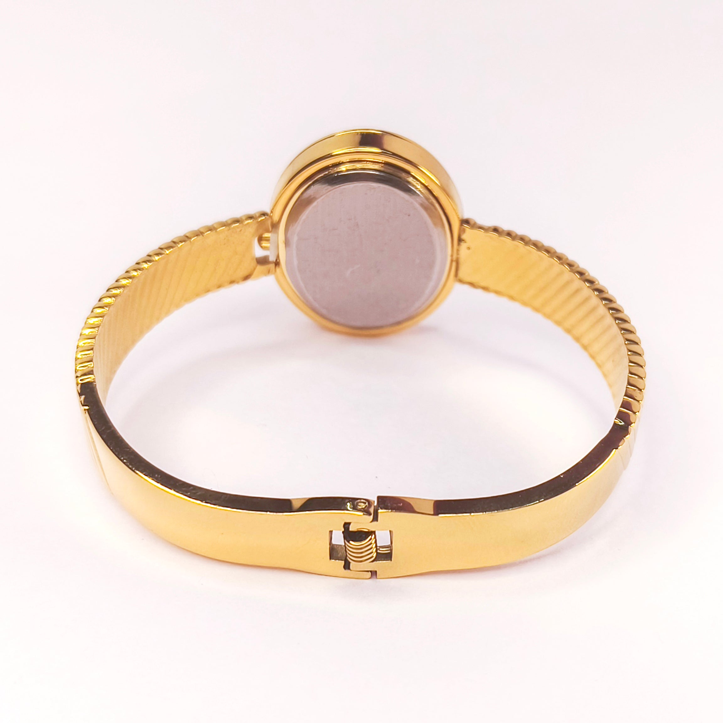 Gold-toned ladies' metal bangle watch with a textured bracelet and round case.